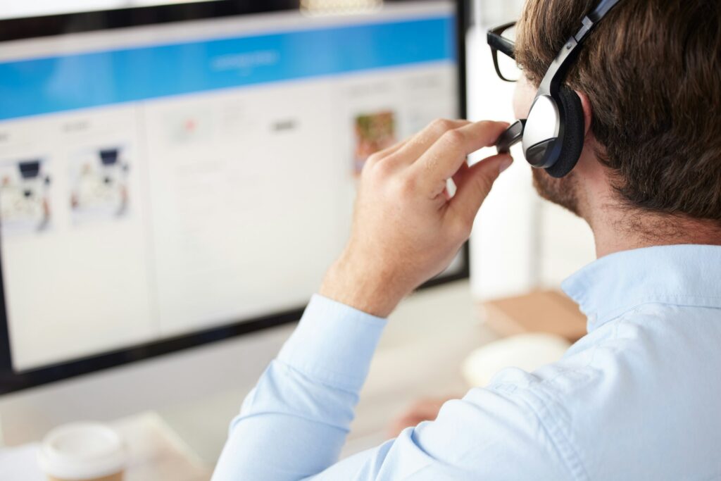 Man, call center and headset for phone call, talking with clients and telemarketing in office at de